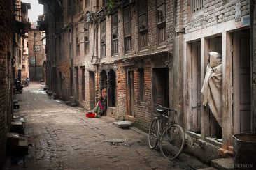A man and a woman on a back street of Baktapur. Nepal.