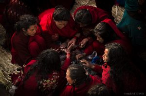 Nepalese women sitting in a circle during their morning fasting rituals