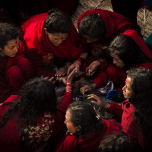 Nepalese women sitting in a circle during their morning fasting rituals