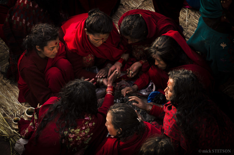 Nepalese women sitting in a circle during their morning fasting rituals